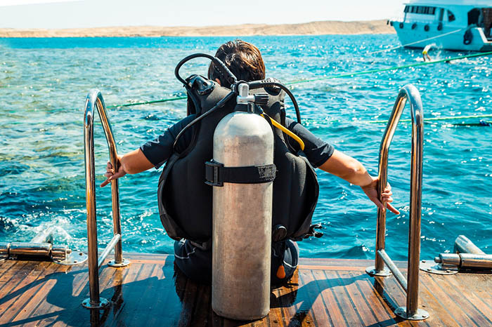 Diver in gear sitting on the deck