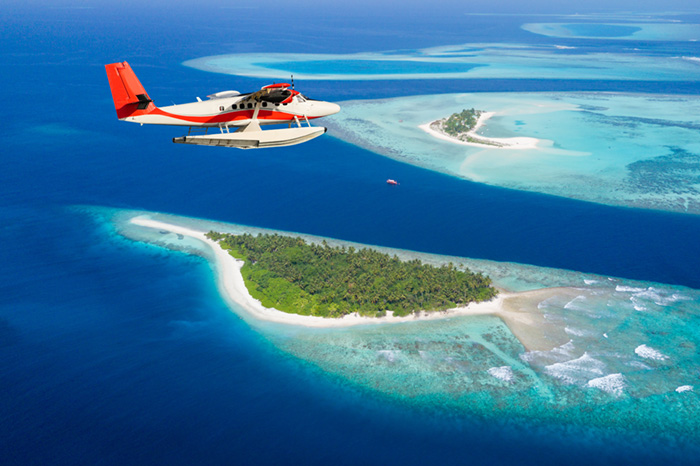 Sea plane flying above Maldives